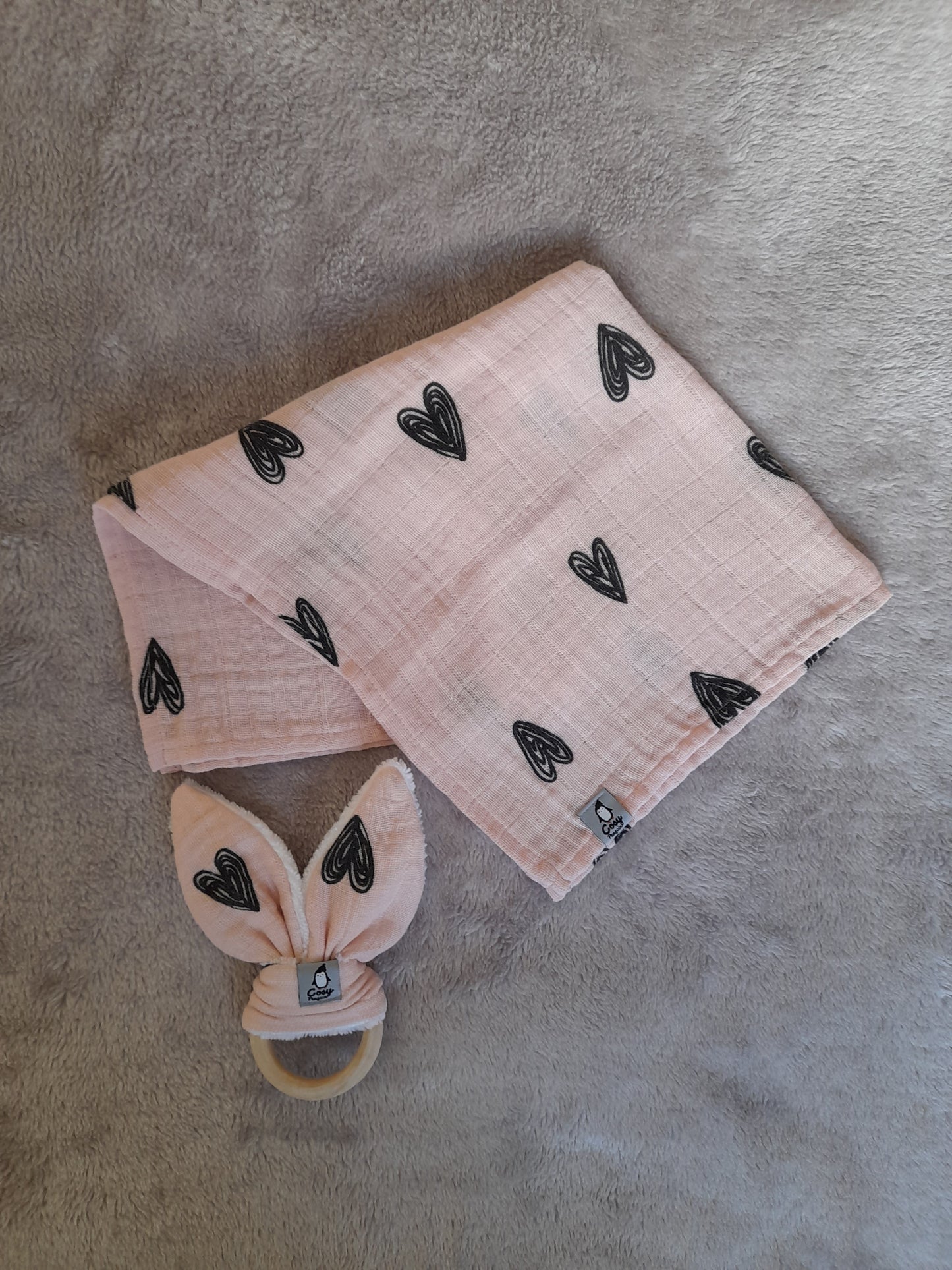 Muslin gift set F1 – set of 4 - Pale pink with black hearts. Muslin, Socks, Wooden ring and Baby burp cloth.