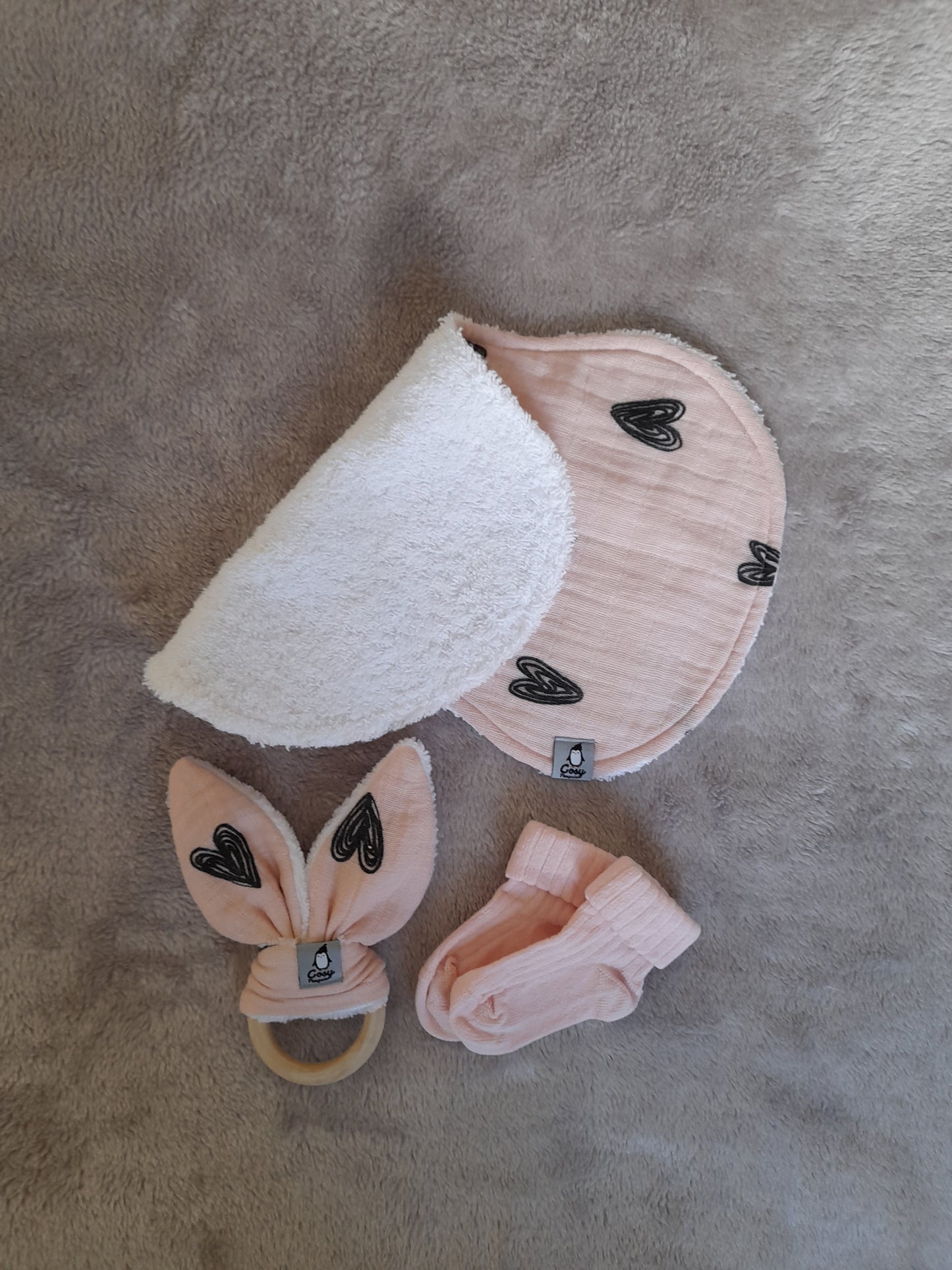 Muslin gift set F1 – set of 4 - Pale pink with black hearts. Muslin, Socks, Wooden ring and Baby burp cloth.